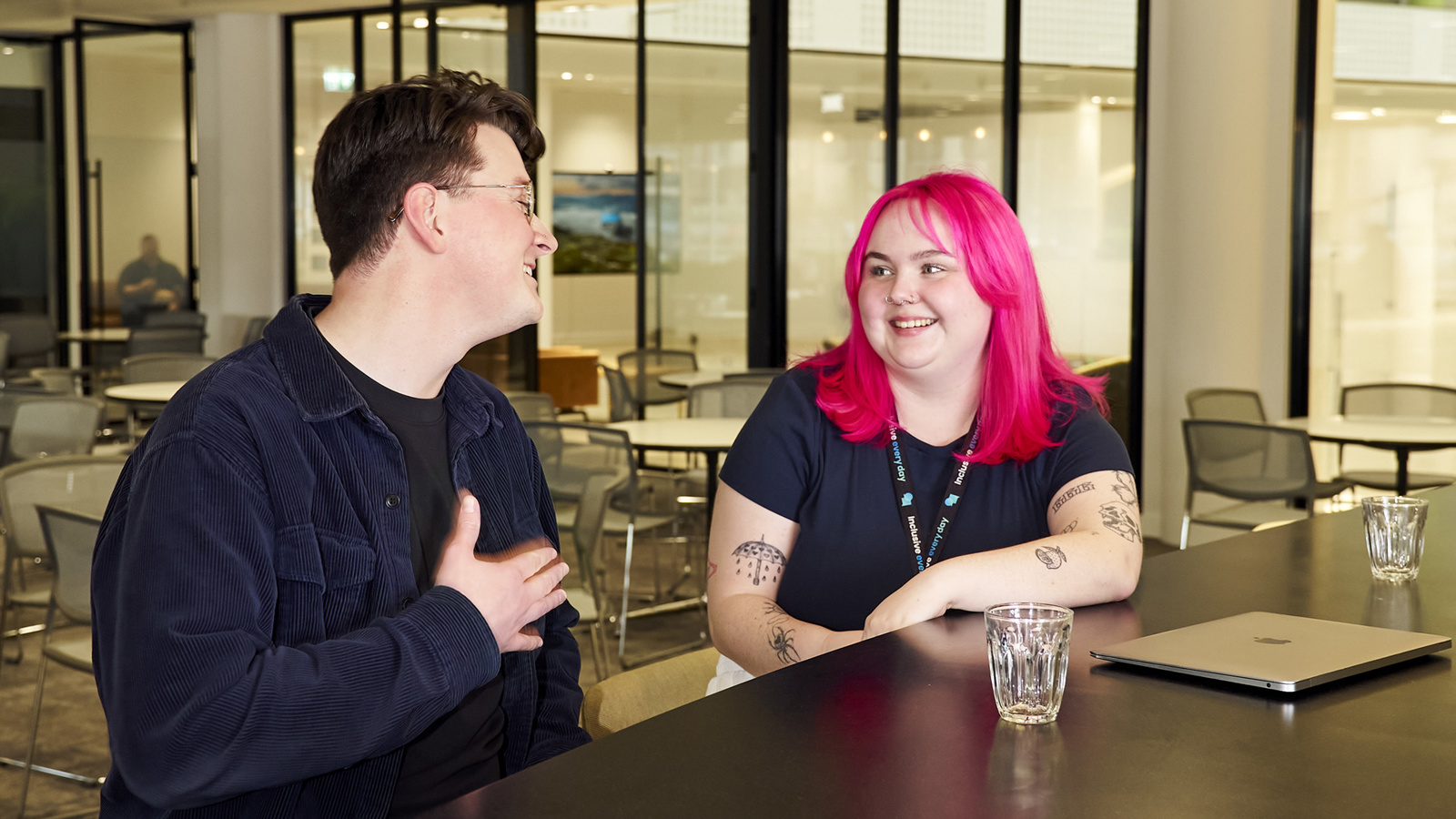 a person and person talking at a table
